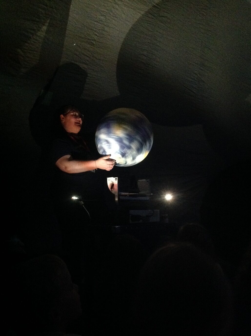 A person holding a large ball

Description automatically generated