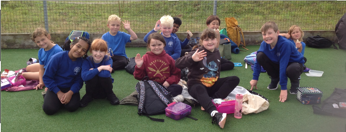 A group of children sitting on the ground

Description automatically generated